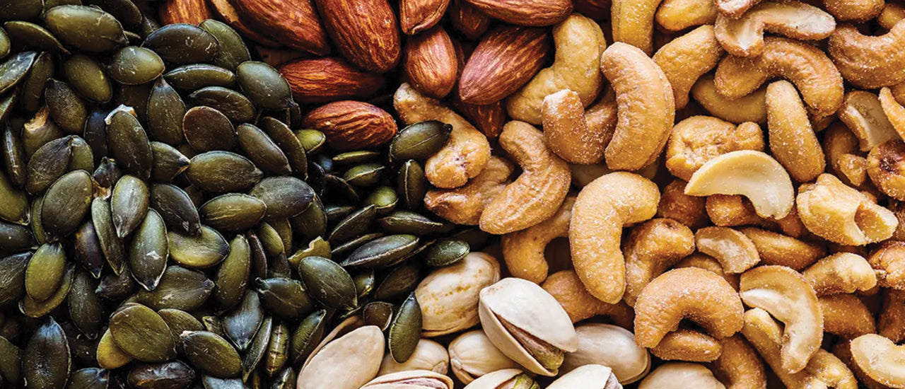 Assorted premium nuts and seeds including almonds, cashews, and pumpkin seeds. Camel Nuts Singapore