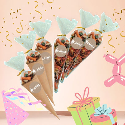 Cones filled with snacks on a pink background with party decorations. Camel Nuts Singapore. Ideal for birthday parties.