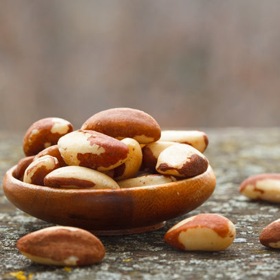Pile of Brazil nuts in a wooden bowl by Camel Nuts Singapore