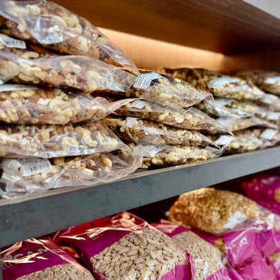 Shelf with stacked packages of mixed nuts and seeds. Camel Nuts Singapore