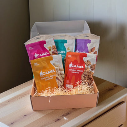 Box of Camel Nuts snack packets on a wooden surface