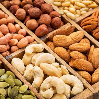 Assorted nuts in wooden boxes. Shop almonds, cashews, hazelnuts, peanuts, pecans, pumpkin seeds and more in Camel Nuts Singapore