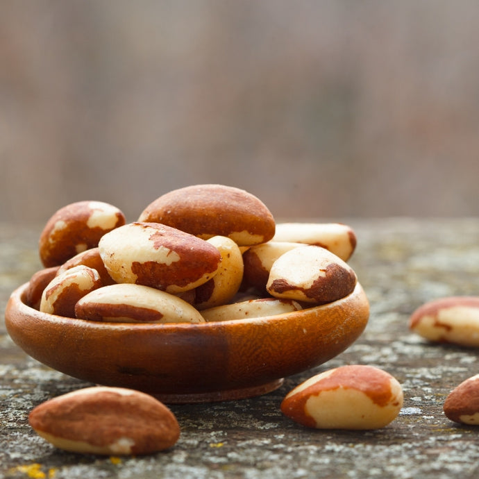 Pile of Brazil nuts in a wooden bowl by Camel Nuts Singapore