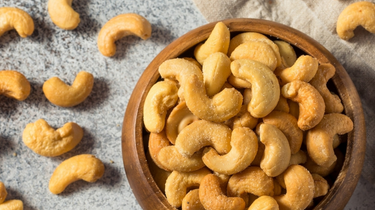 Singapore's Camel Nuts cashews in wooden bowl – Salted cashews served in a rustic wooden bowl.
