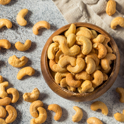 Camel Nuts Singapore cashews in wooden bowl – Salted cashews served in a rustic wooden bowl.