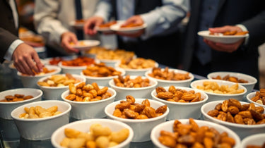 People serving themselves from an event buffet table with various nut options. Camel Nuts Singapore