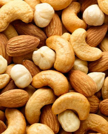 Close-up of a mix of nuts including cashews, almonds, and hazelnuts. Fancy Mixed Nuts in Singapore by Camel Nuts