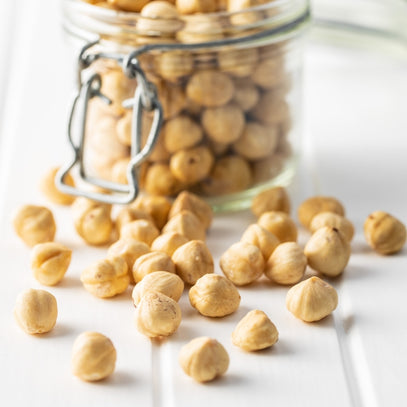 Glass jar filled with hazelnuts. Camel Nuts Singapore