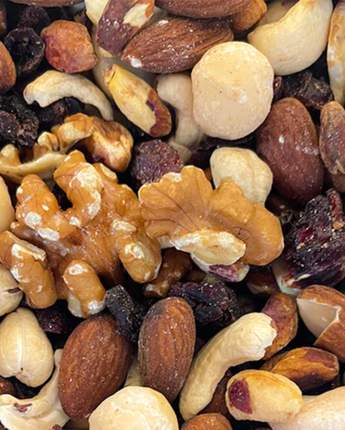 Assorted nuts and dried fruits including almonds, walnuts, and raisins Shop Natura Baked Ruby Mix at Camel Nuts