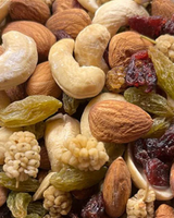 Assorted nuts and dried fruits including cashews, almonds, raisins, and cranberries. Buy nuts at Camel Nuts