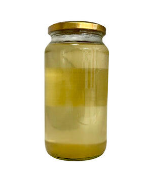 Glass jar with a gold lid containing Organic Cooking Coconut Oil