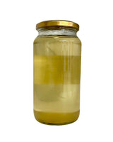 Glass jar with a gold lid containing Organic Cooking Coconut Oil