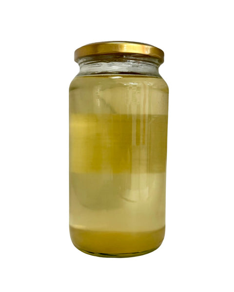 Glass jar with a gold lid containing Organic Cooking Coconut Oil